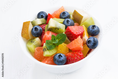 Delicious fruit salad in a bowl, top view