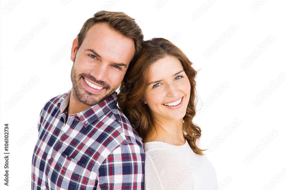 Happy young couple standing back to back Happy young couple standing back to back
