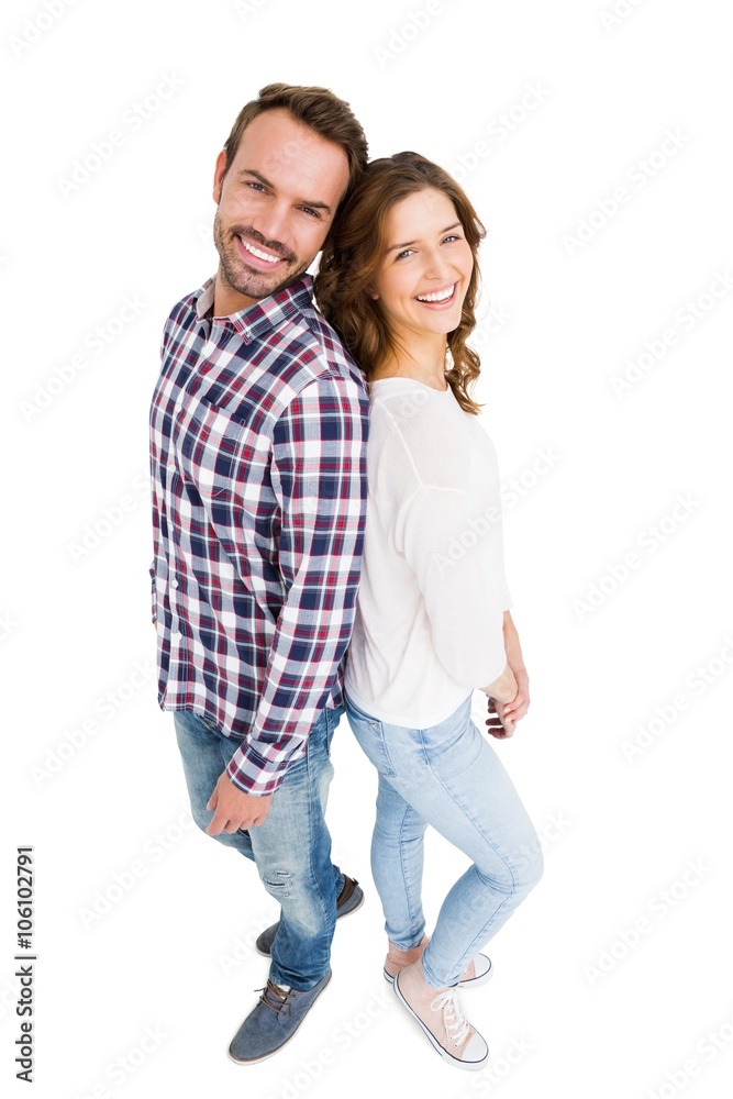 Happy young couple standing back to back Happy young couple standing back to back