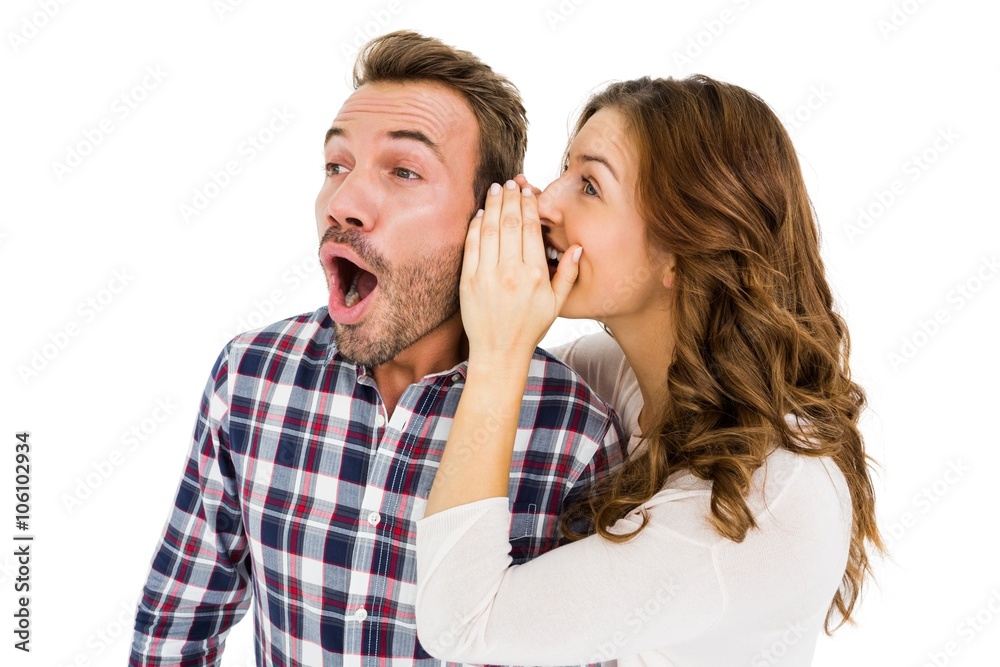 Woman whispering into mans ears Woman whispering into mans ears