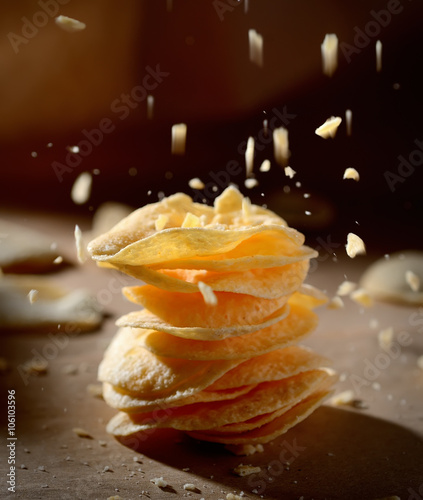 potato chips in a stack on a dark background
 photo