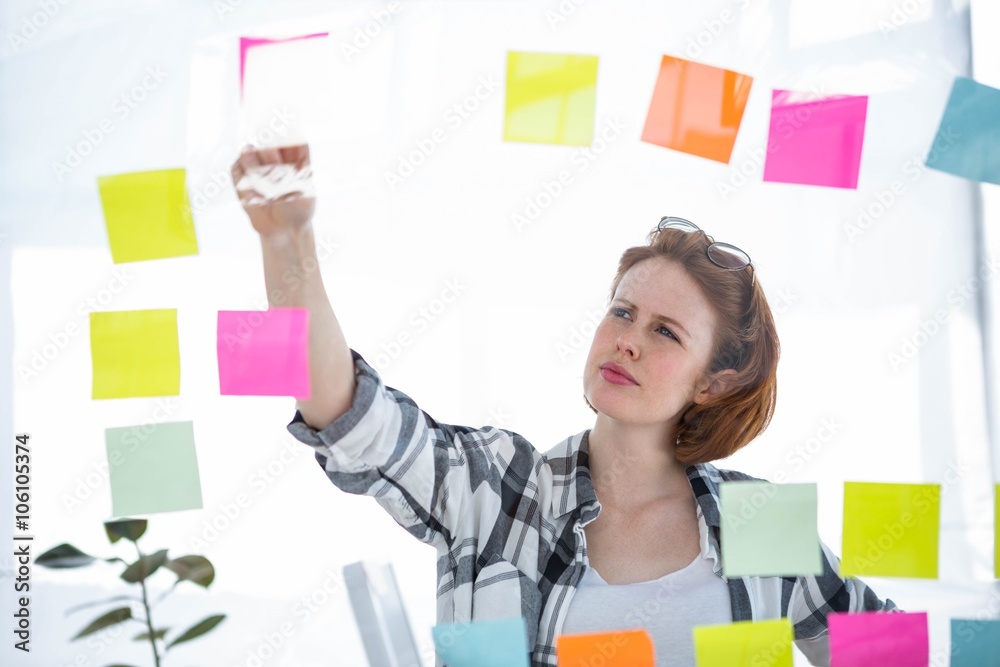 thoughtful hipster woman brainstorming over notes thoughtful hipster woman brainstorming over notes