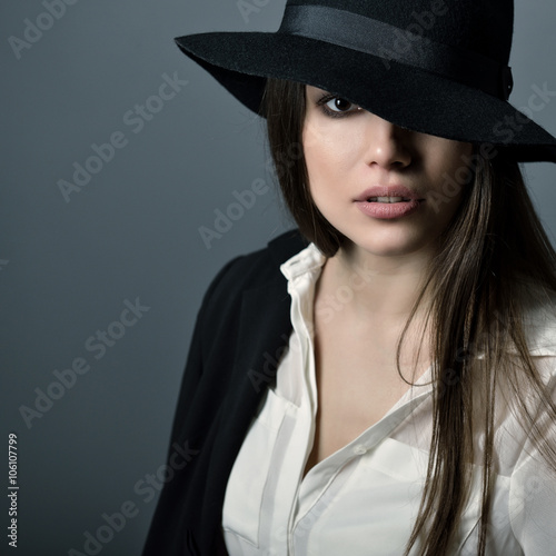 Young beautiful sexy woman in jacket, white shirt and hat over g © Khorzhevska