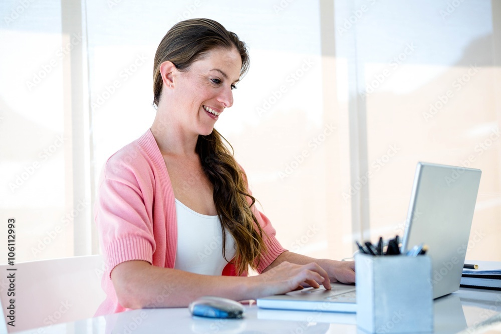 smiling buwiness woman typing on her laptop smiling buwiness woman typing on her laptop