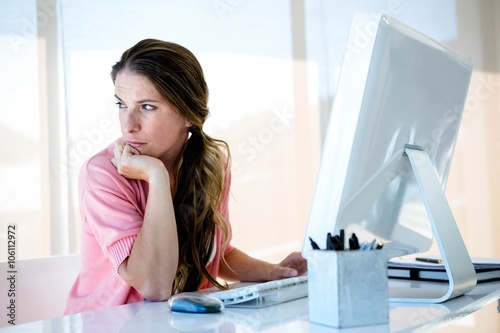 distracted business woman looking away from her computer