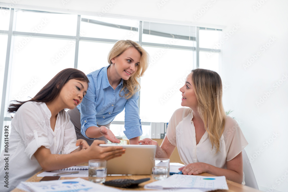 Group of business women discussing project in the office Group of business women discussing project in the office