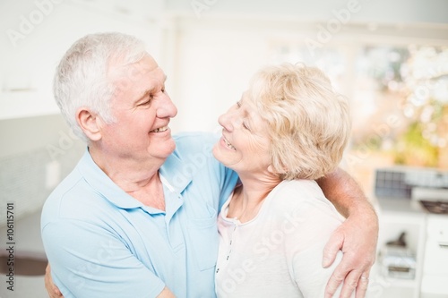 Happy senior couple smiling while looking at eachother