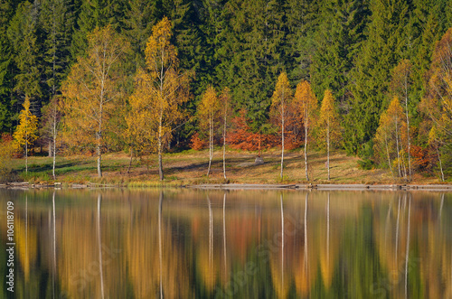 Autumn Landscape. Mountains in Autumn. The bright colors of autumn in the park by the lake.