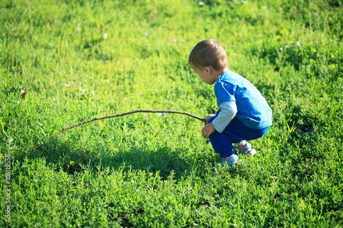 portrait of cute little boy playing on the grass