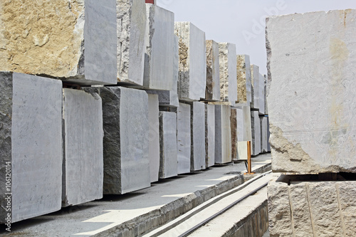 Huge Indian granite blocks stacked in a stone processing factory for cutting and polishing into flooring slabs used in building construction.
