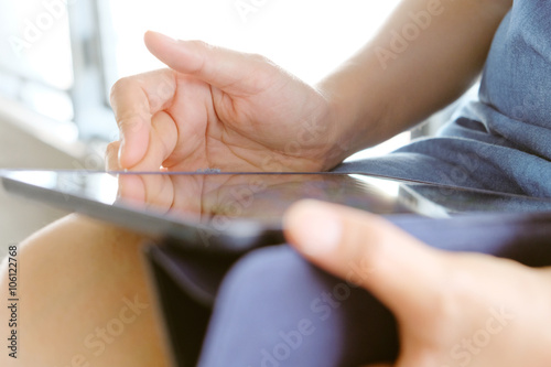 Social Media Life,close up image of business women Sitting in the Skytrain station and Using digital tablet.