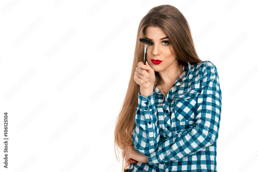 Horizontal portrait of fun makeup artist girl with brush in hand Horizontal portrait of fun makeup artist girl with brush in hand