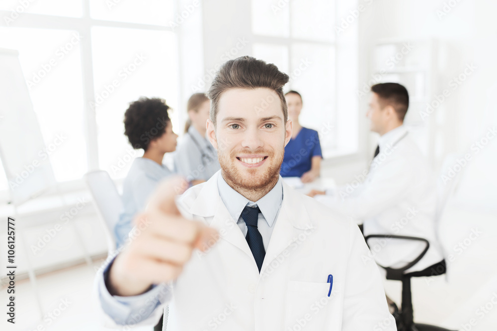 happy doctor over group of medics at hospital