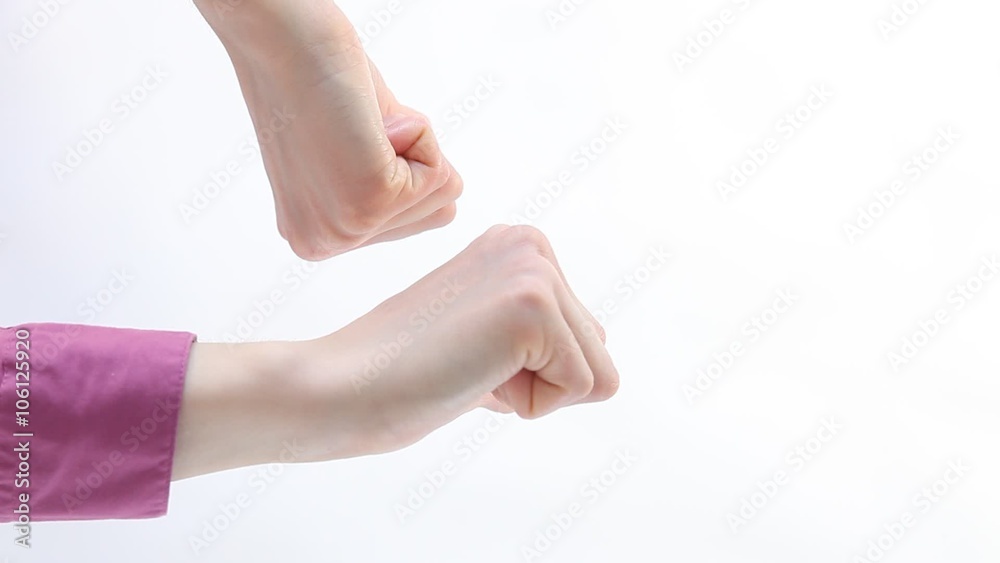 Female hands showing thumbs down sign, white background Female hands showing thumbs down sign, white background