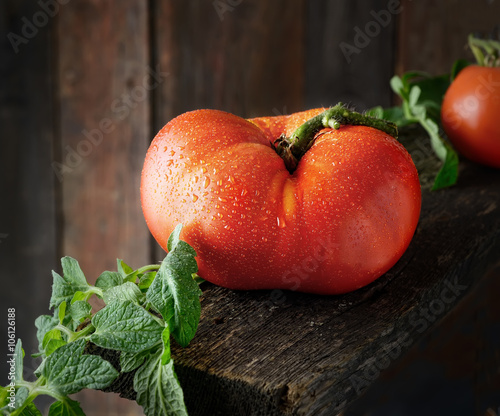 juicy big tomato on a wooden background
 photo