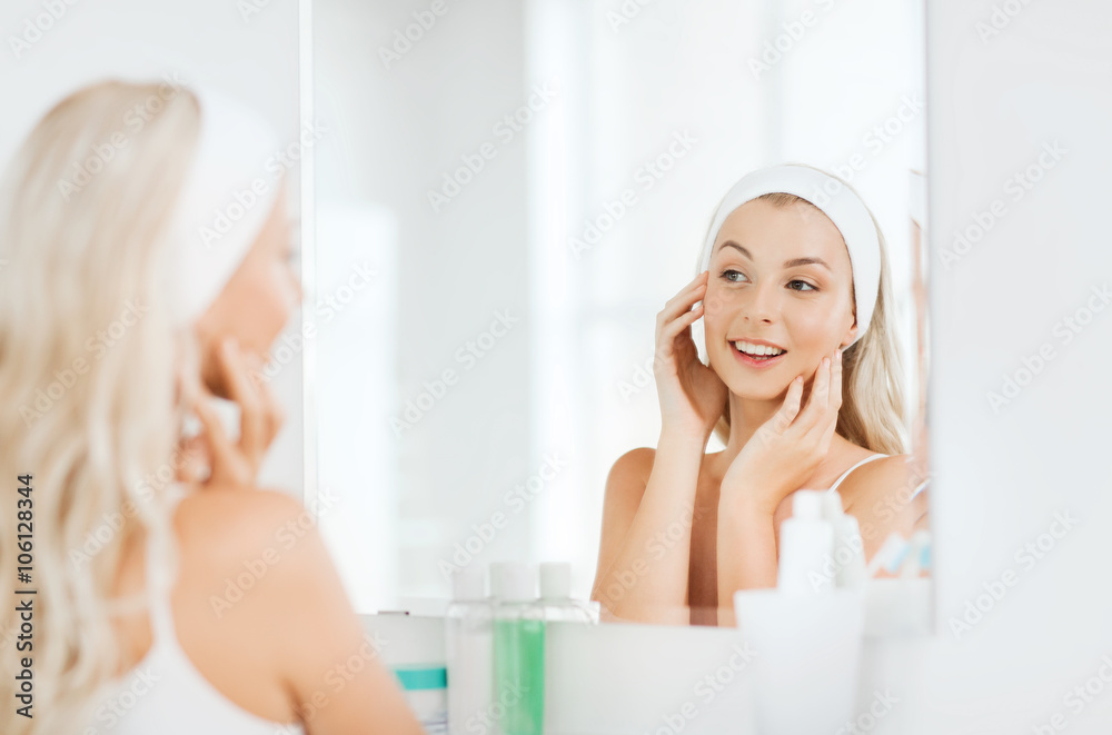 woman in hairband touching her face at bathroom woman in hairband touching her face at bathroom