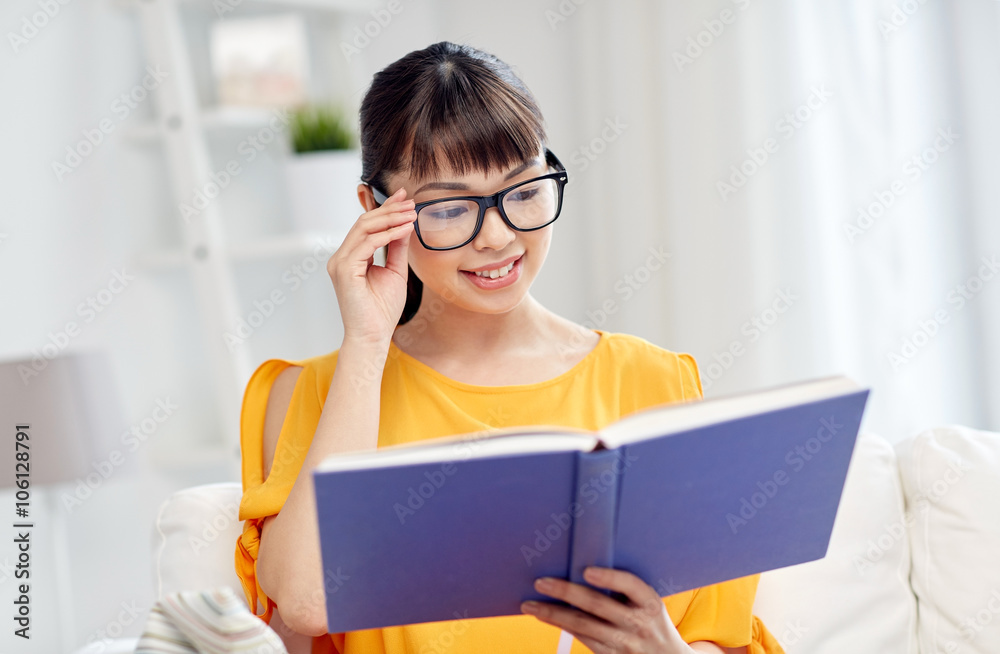 smiling young asian woman reading book at home smiling young asian woman reading book at home