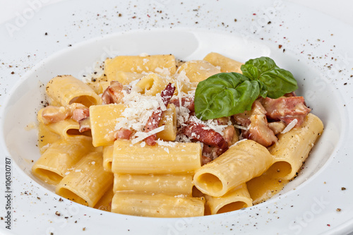 Italian rigatoni pasta with prosciutto, parmesan cheese and leaf