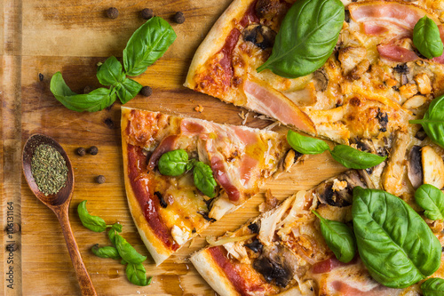 Fresh pizza served on wooden table photo