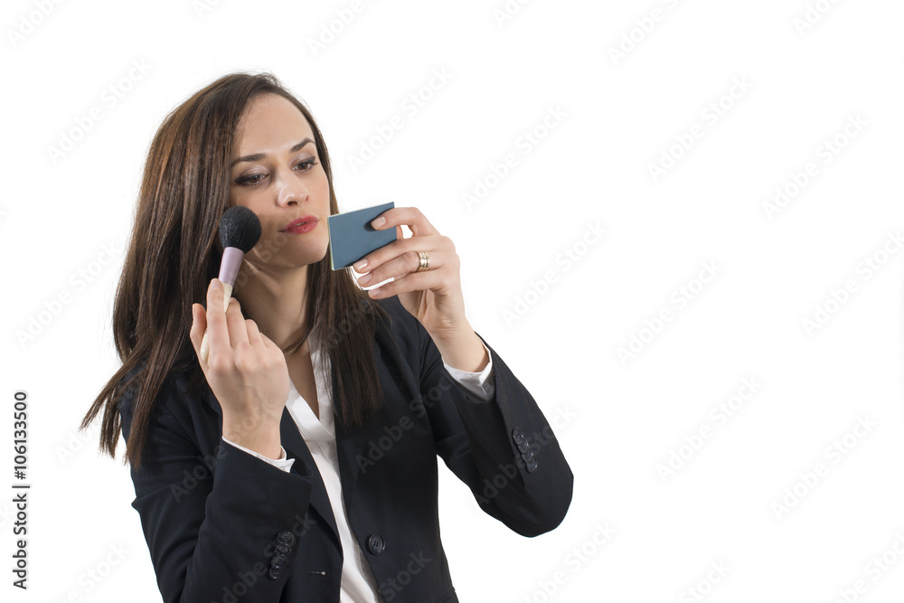 Beautiful young business woman applying her eye makeup, isolated on white background Beautiful young business woman applying her eye makeup, isolated on white background