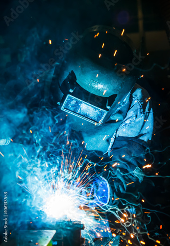 Welder and bright sparks. Construction and manufacturing
