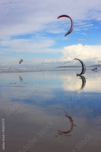 kitesurfers on a beach