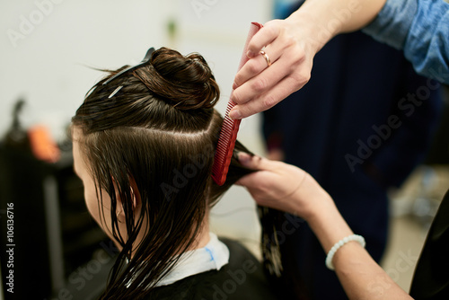 Hairdresser girl combing her hair