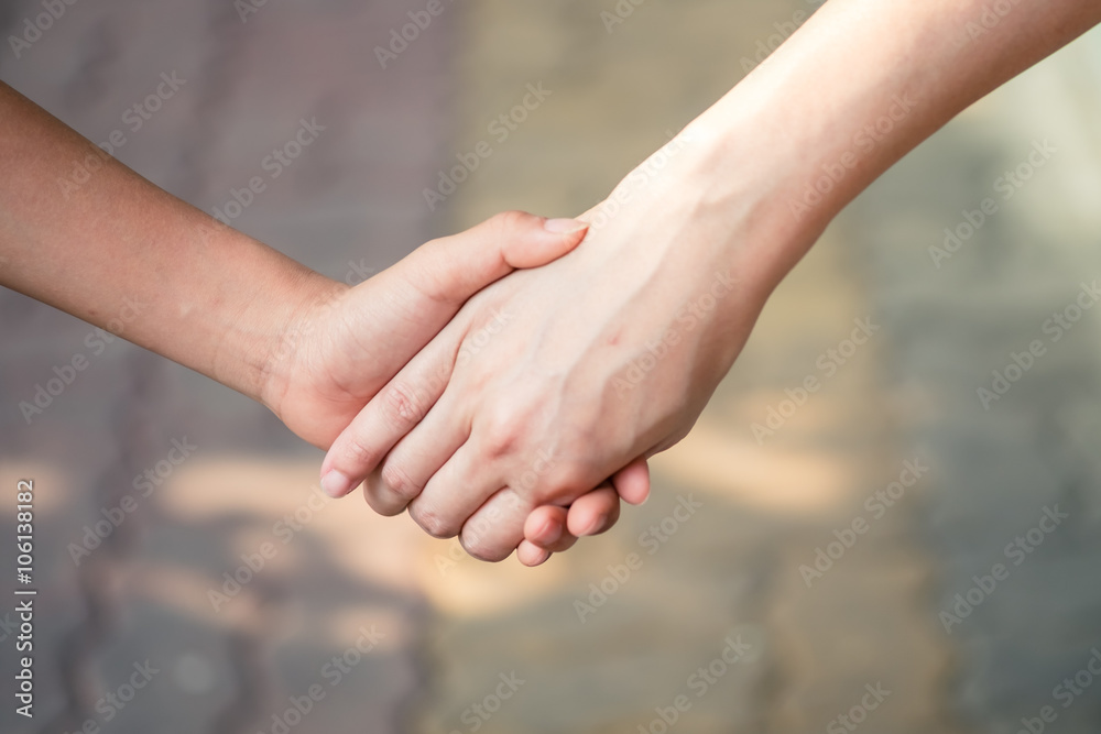 Mother holding a hand of her son