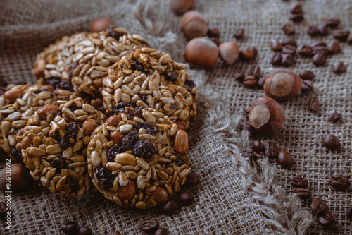 Roasted coffee beans, muesli with nuts on the wooden background