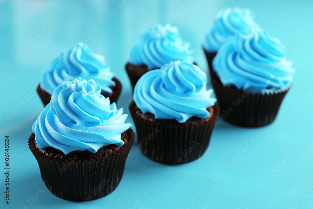 Chocolate cupcakes on blue background Chocolate cupcakes on blue background