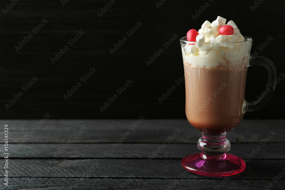 Cup of coffee with whipped cream and candies on black background Cup of coffee with whipped cream and candies on black background