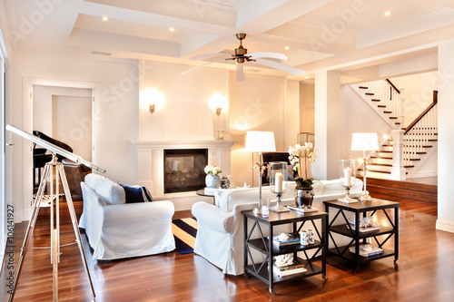 Beautiful drawing room with glossy wooden floor and telescope at photo