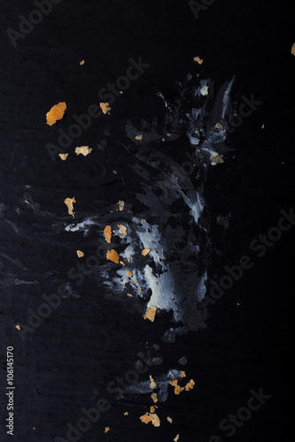 Cream footprint and crumbs from the cake on a black background