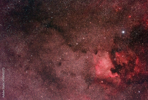 North America Nebula (NGC7000) connected to a large molecular cloud by a trace of smaller clouds.