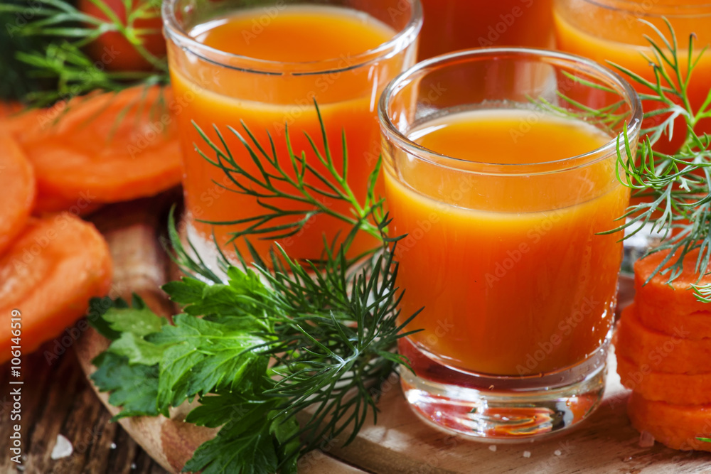 Freshly squeezed carrot juice in glasses, selective focus Freshly squeezed carrot juice in glasses, selective focus