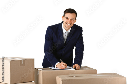 Delivery concept. Man in black suit with carton boxes isolated on white background © Africa Studio