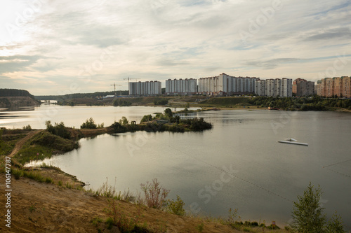 residential houses on the banks of a large lake © sa4e4ek