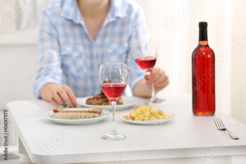Dinner with glass of wine indoors