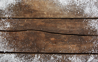 Snowy brown wooden background