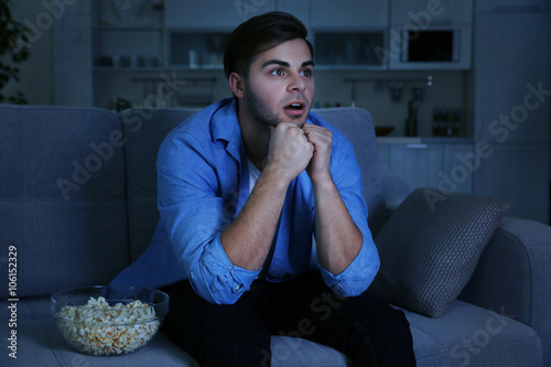 Young handsome man watching...