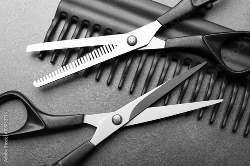 Barber set with comb and scissors on grey background, close up