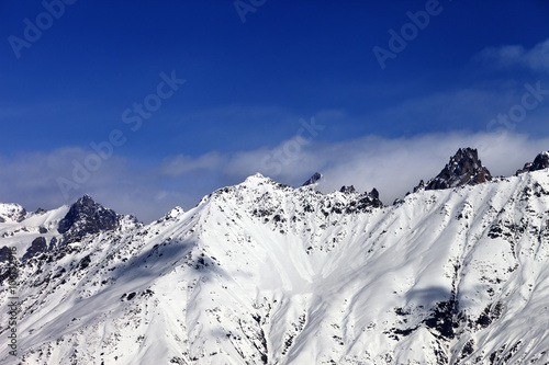 View on snowy mountains in haze at sunny day © BSANI