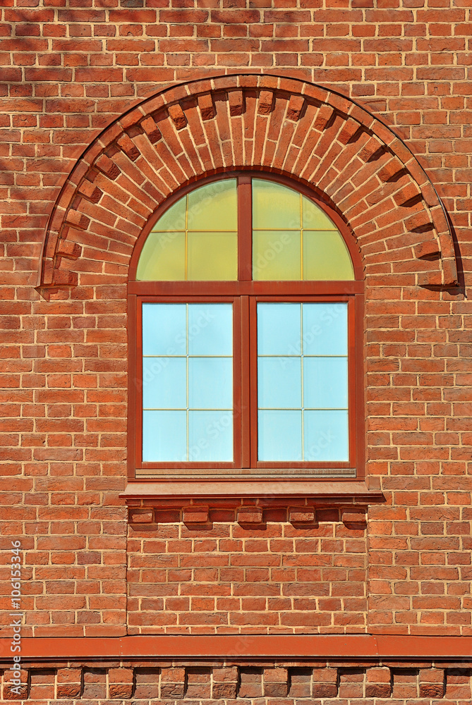 Window with an arch on the background wall of red brick. From the series window of Saint-Petersburg.