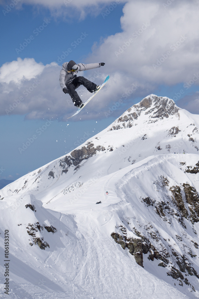 Flying snowboarder on mountains. Extreme sport. Flying snowboarder on mountains. Extreme sport.