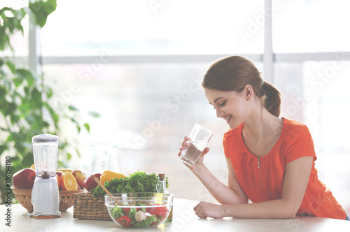 Young woman drinking water ...