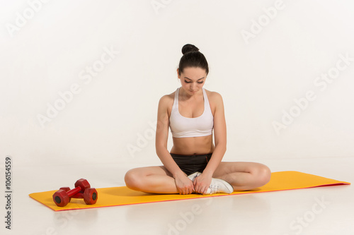 attractive woman doing exercises. Brunette fit body on yoga mat © nazarovsergey