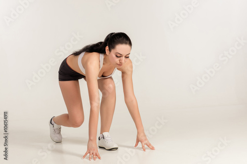 Fitness woman getting ready to start running. 