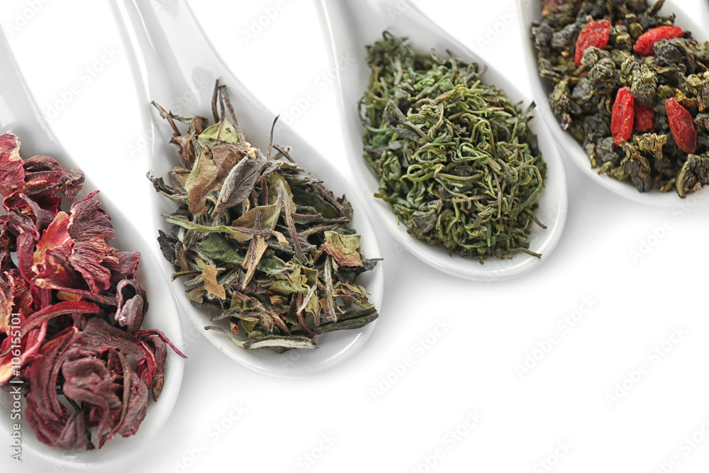 Fototapeta premium Variety of dry tea in spoons isolated on white