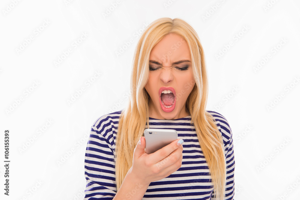Pretty angry young blonde shouting on her mobile phone Pretty angry young blonde shouting on her mobile phone
