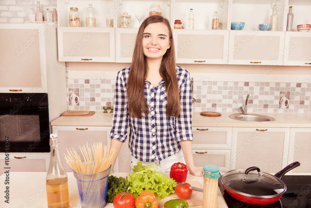 Attractive young woman posing in the kitchen and going to make d Attractive young woman posing in the kitchen and going to make d